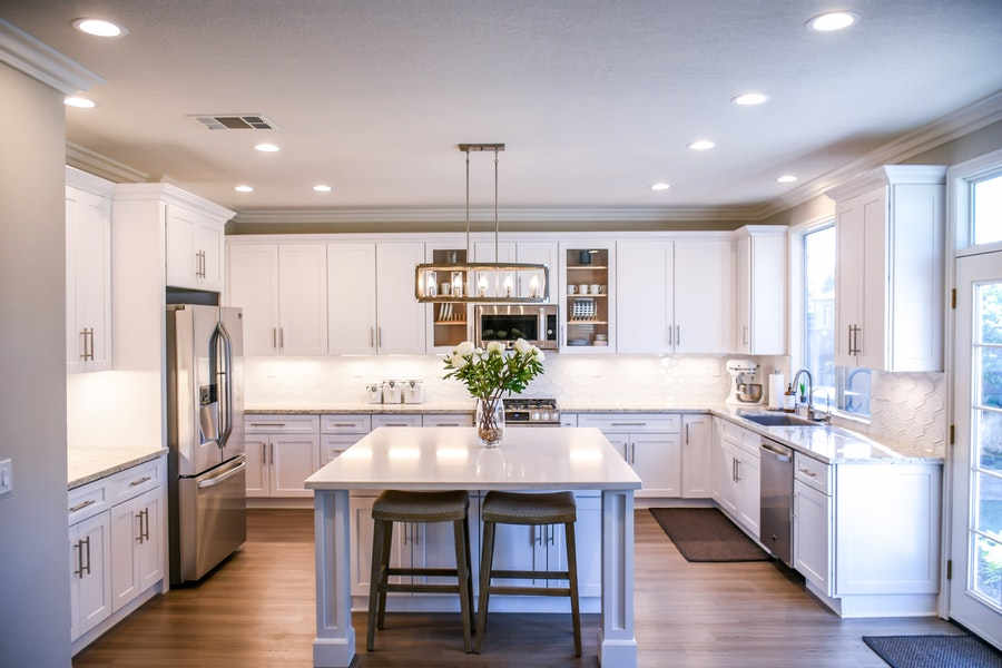 A clean kitchen with flower on the table