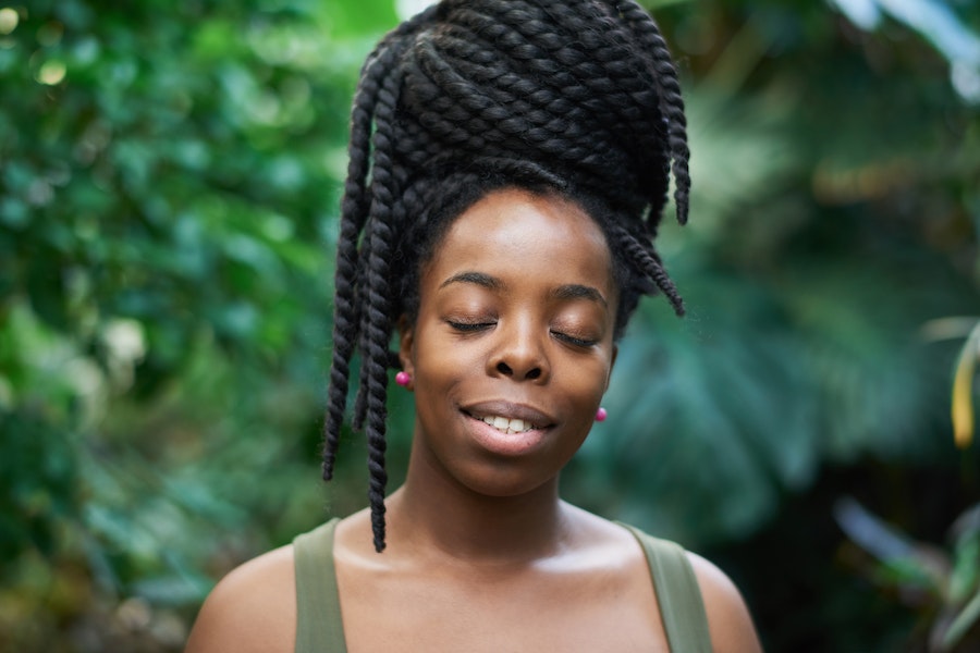 Cost of hiring a hair stylist: a lady with dreadlock